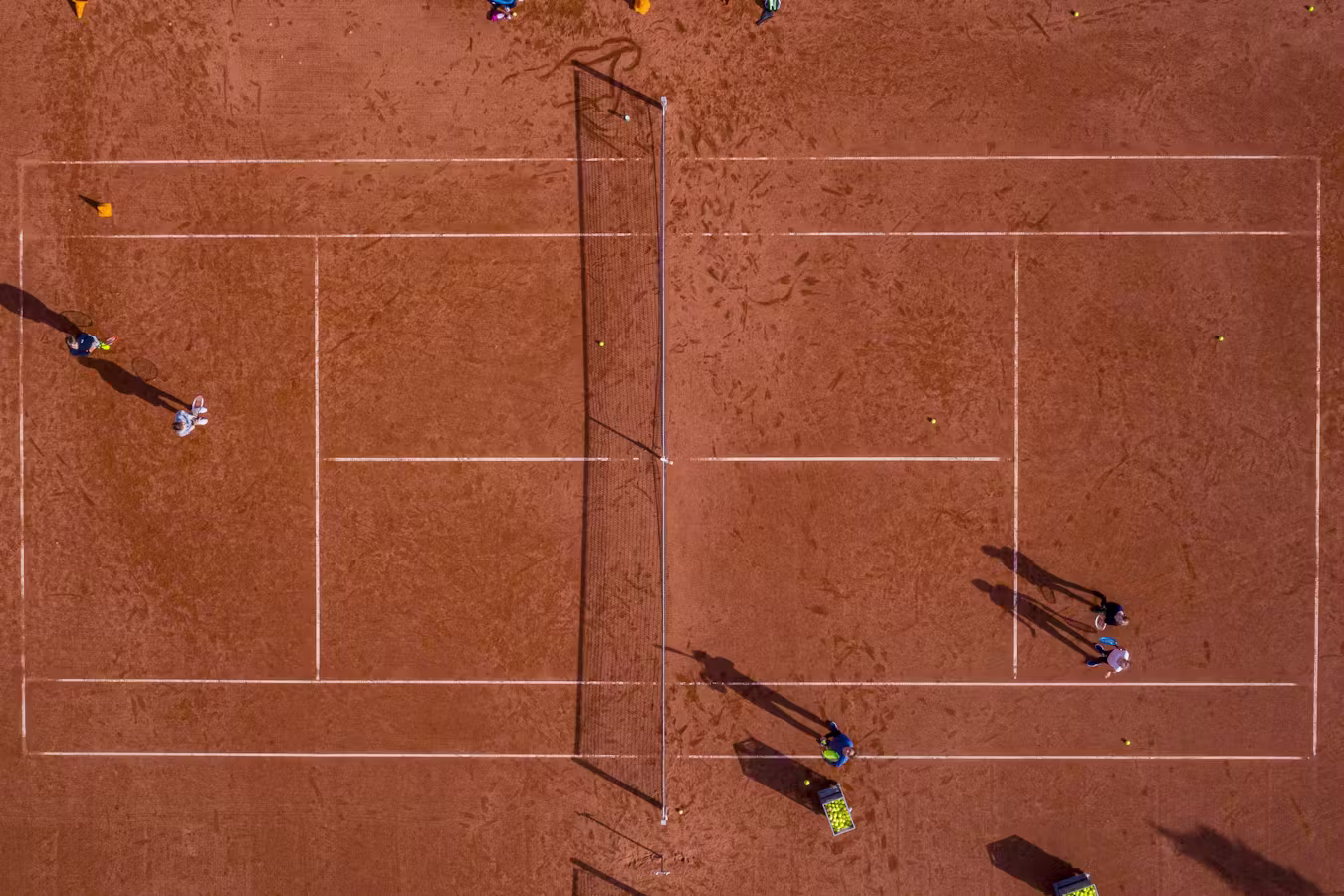 Clay court seen from above during a lesson